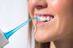 The How and Why of Water Flossing: Protecting Your Investment in Full Mouth Dental Implants